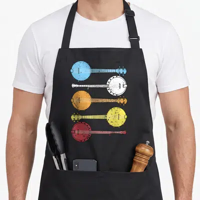 Banjo country apron - Five banjos in blue white orange yellow red stacked vertically facing alternating directions — shown on a black cotton canvas apron against a white background