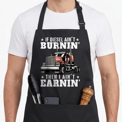 Mechanic semi truck apron - Distressed orange semi truck graphic with white stars and text IF DIESEL AIN'T BURNIN' THEN — shown on a black cotton canvas apron against a white background