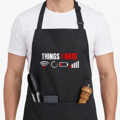 Hate geek apron - THINGS I HATE text above wifi loading low battery and signal bars in white and red — shown on a black cotton canvas apron against a white background