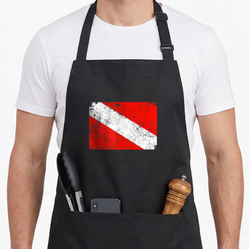 Worn diving apron - Distressed red and white diagonal stripe diving flag graphic — shown on a black cotton canvas apron against a white background