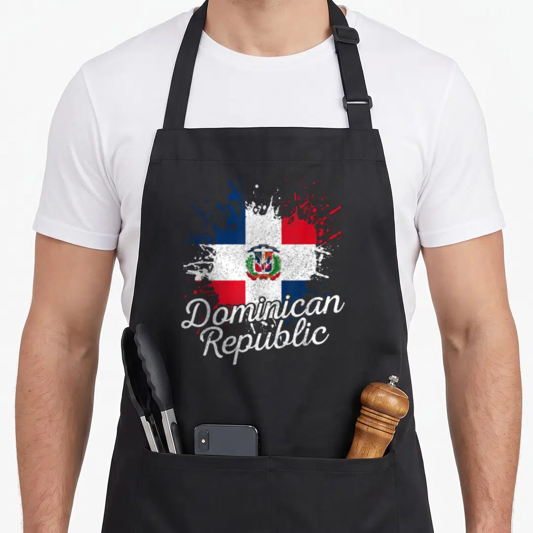 Dominican patriotic apron - Red white blue flag splatter with curved Dominican Republic script text — shown on a black cotton canvas apron against a white background