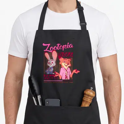 Hopp novelty apron - Judy Hopps and Nick Wilde cartoon art with Zootopia and Undercover text in pink and purple — shown on a black cotton canvas apron against a white background