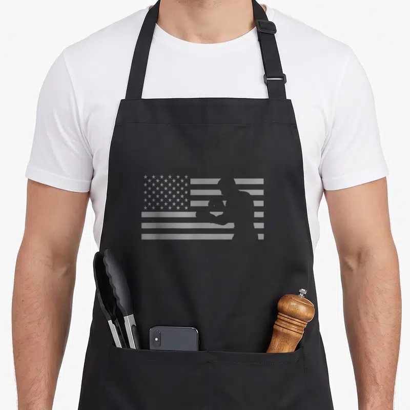 Boxing american flag apron - Grey USA flag with boxer silhouette integrated into stripes — shown on a black cotton canvas apron against a white background