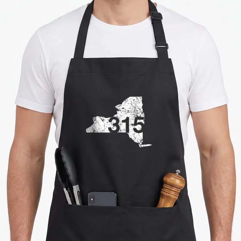 Syracuse new york apron - Distressed white NY state map with 315 area code printed in grey — shown on a black cotton canvas apron against a white background