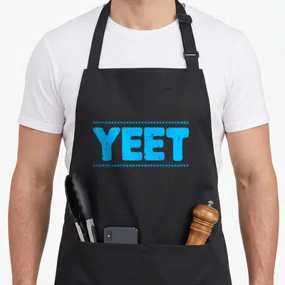 Yeet novelty apron - Blue block letters reading YEET framed by rows of small directional arrows — shown on a black cotton canvas apron against a white background