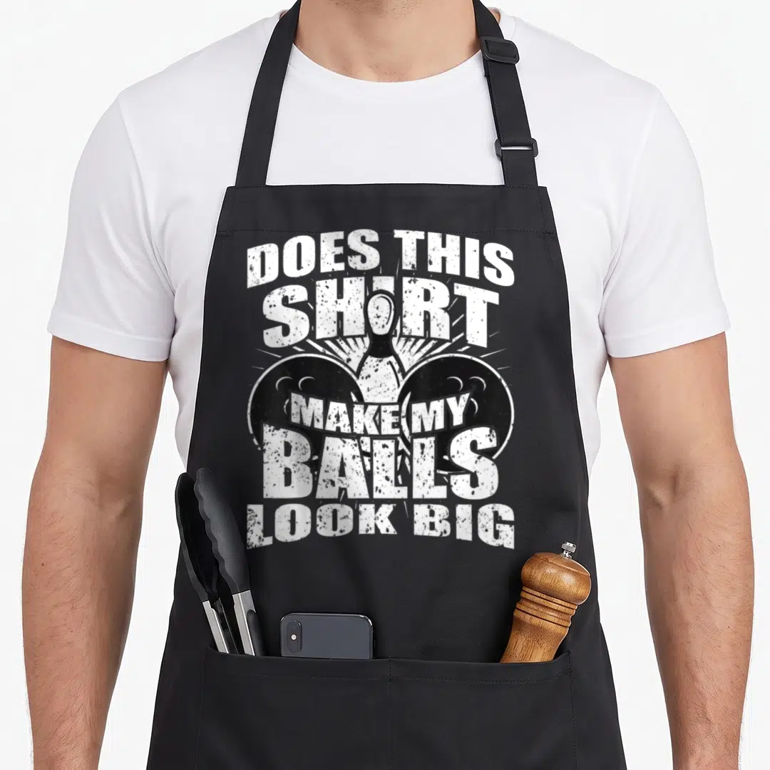 Bowling gag aprons - Distressed white text over bowling pin and two black balls on black background — shown on a black cotton canvas apron against a white background