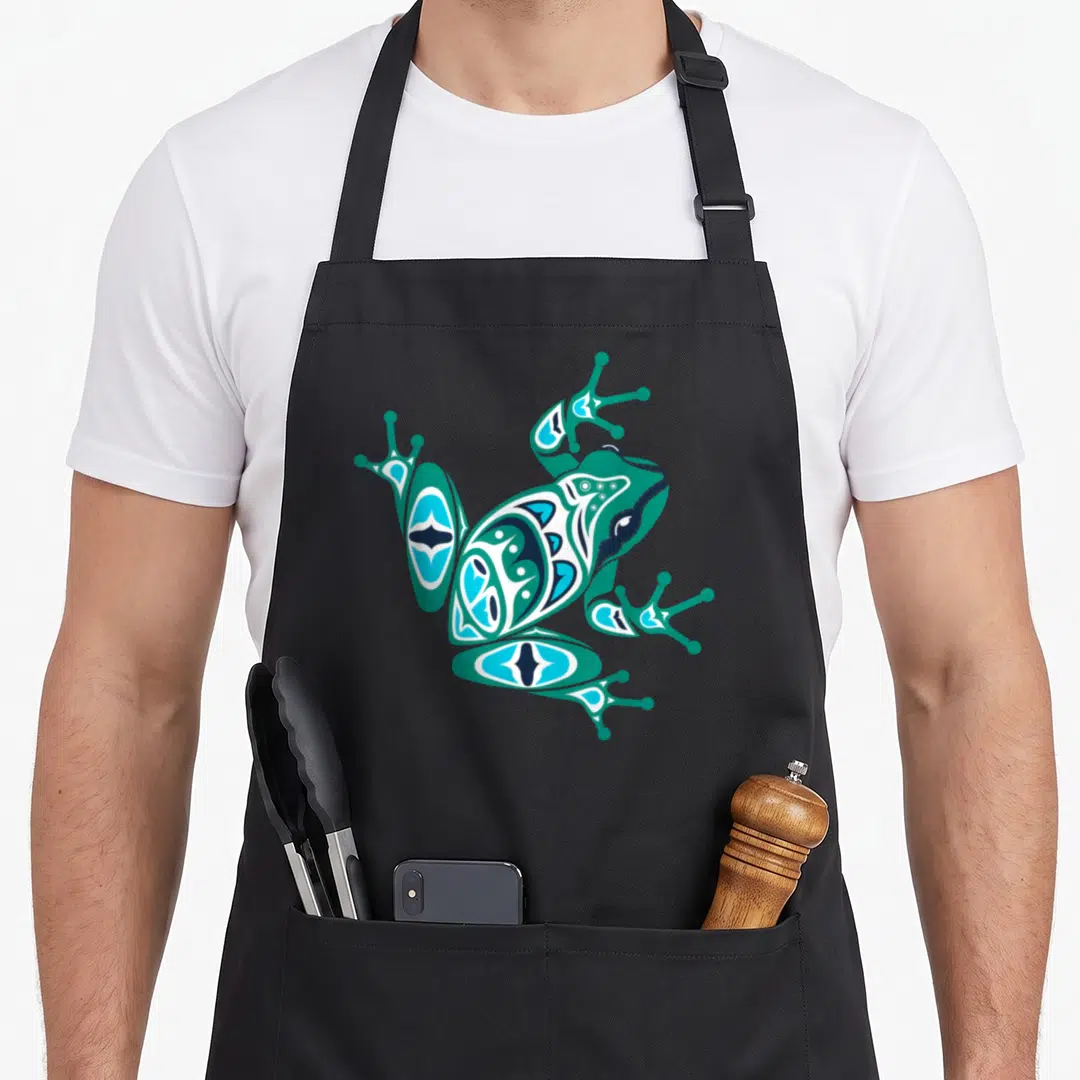 Frog native american apron - Stylized teal and blue frog in Pacific Northwest line art on black fabric — shown on a black cotton canvas apron against a white background