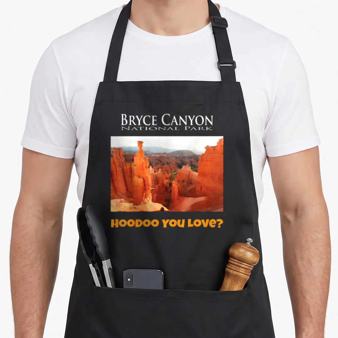 Bryce canyon apron - Orange rock hoodoos photo with Bryce Canyon National Park text and Hoodoo You Love pun — shown on a black cotton canvas apron against a white background