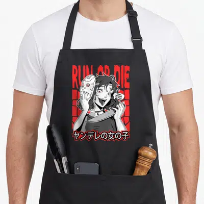 Yandere anime apron - Cartoon girl holding hockey mask and knife with RUN OR DIE text and Japanese characters — shown on a black cotton canvas apron against a white background