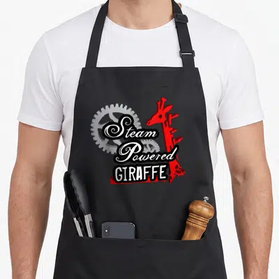 Steam giraffe apron - Red mechanical giraffe next to two grey gears with white text reading Steam Powered GIRAFFE — shown on a black cotton canvas apron against a white background