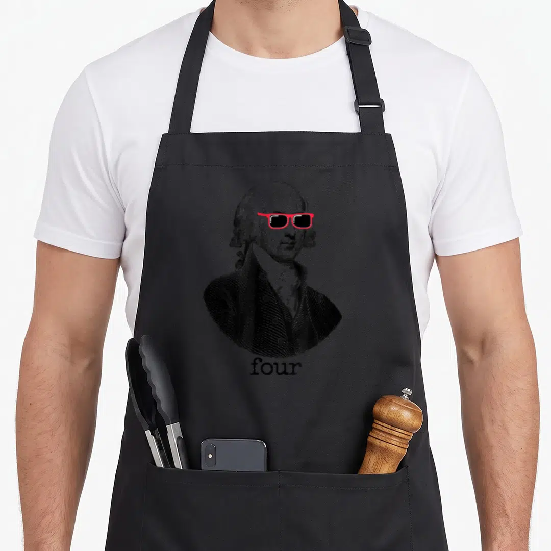 Presidential madison apron - Portrait of man with red sunglasses and word four printed on black fabric — shown on a black cotton canvas apron against a white background