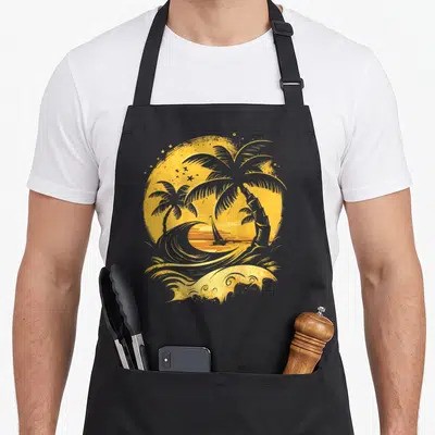 Island tree apron - Retro circular sunset with palm trees, sailboat, and wave in yellow and orange — shown on a black cotton canvas apron against a white background