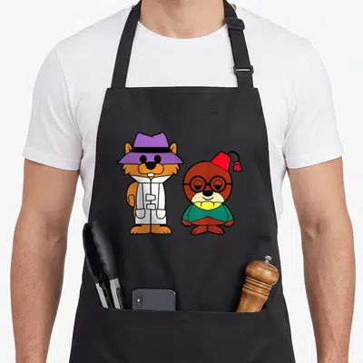 Secret squirrel aprons - Two cartoon animals: orange hamster in purple hat and white coat, brown bear in red hat — shown on a black cotton canvas apron against a white background