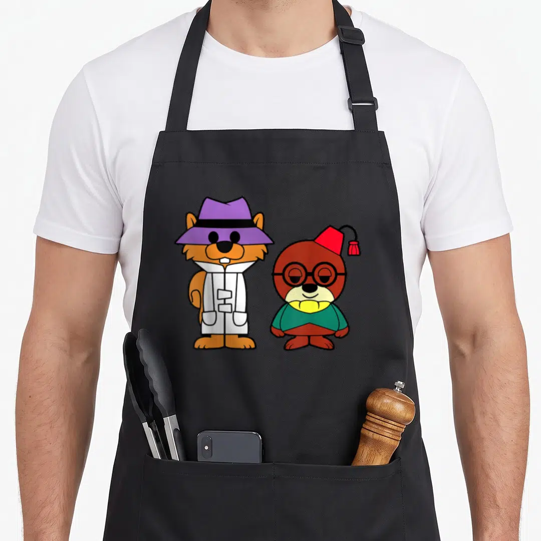 Secret squirrel aprons - Two cartoon animals: orange hamster in purple hat and white coat, brown bear in red hat — shown on a black cotton canvas apron against a white background
