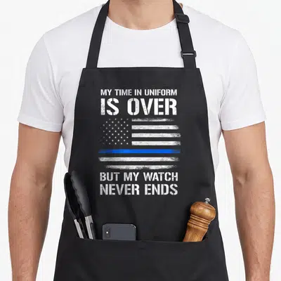 Retired officer police apron - Distressed white and blue flag with one blue stripe and text about watch never ending — shown on a black cotton canvas apron against a white background