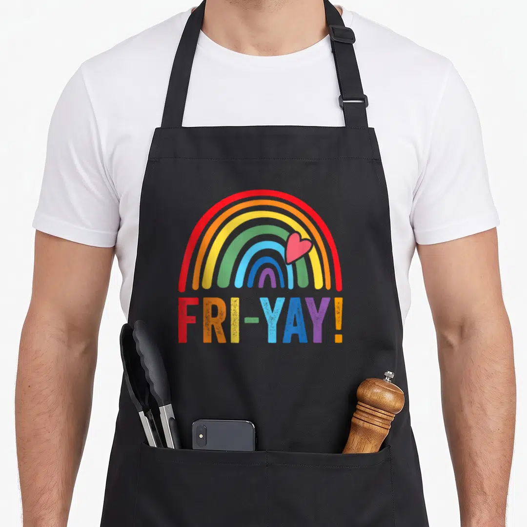 Friyay rainbow teacher apron - Rainbow arch with red heart above FRI-YAY text in rainbow colors — shown on a black cotton canvas apron against a white background