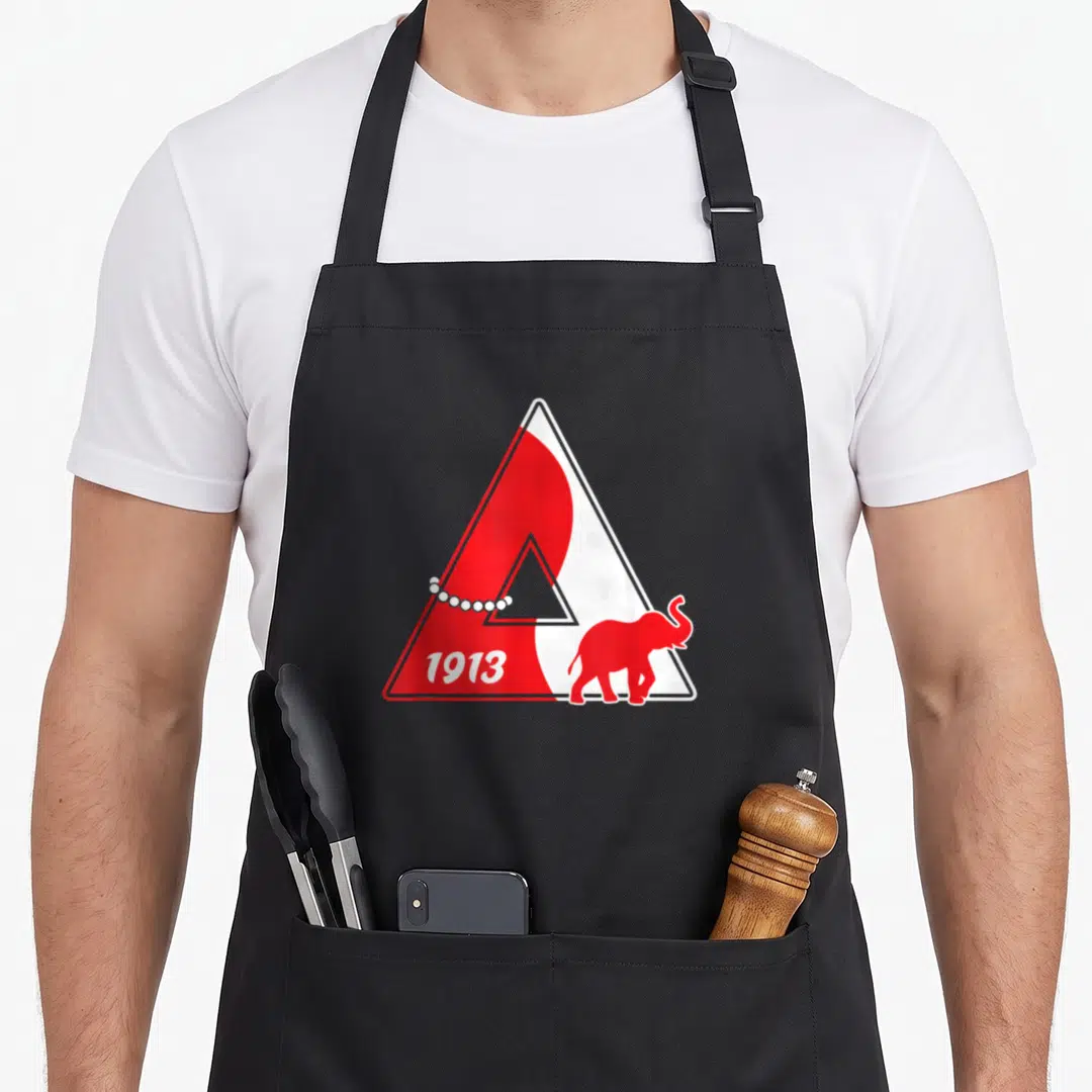 Funny sigma sorority apron - Red and white triangle with 1913 text, red elephant, and pearl string — shown on a black cotton canvas apron against a white background