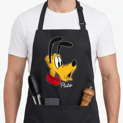 Pluto friends apron - Cartoon head of Pluto in yellow and red with white text below — shown on a black cotton canvas apron against a white background