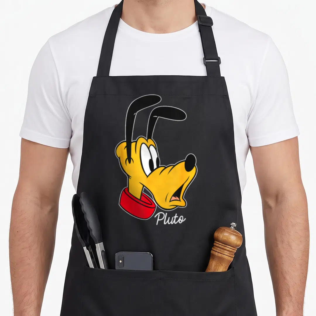 Pluto friends apron - Cartoon head of Pluto in yellow and red with white text below — shown on a black cotton canvas apron against a white background