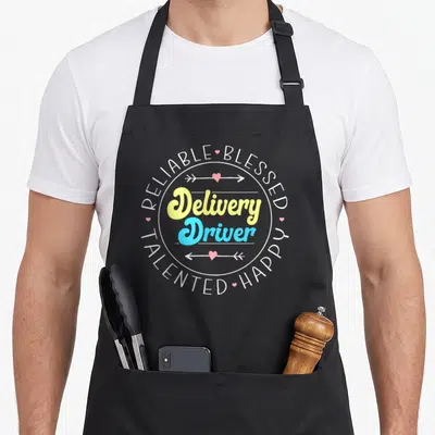 Courier truck apron - Delivery Driver text in yellow and blue script surrounded by Reliable Blessed Happy Talented — shown on a black cotton canvas apron against a white background