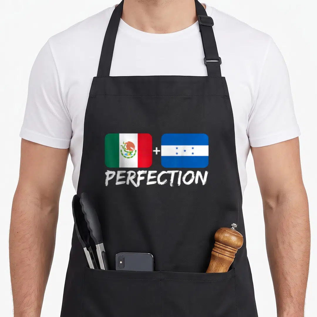 Perfection mexican apron - Two flags with green white red and blue colors plus sign and white text reading PERFECTION — shown on a black cotton canvas apron against a white background