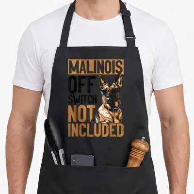 Belgian top dog aprons - Cartoon Malinois dog with sunglasses and text Malinois Off Switch Not Included in orange — shown on a black cotton canvas apron against a white background