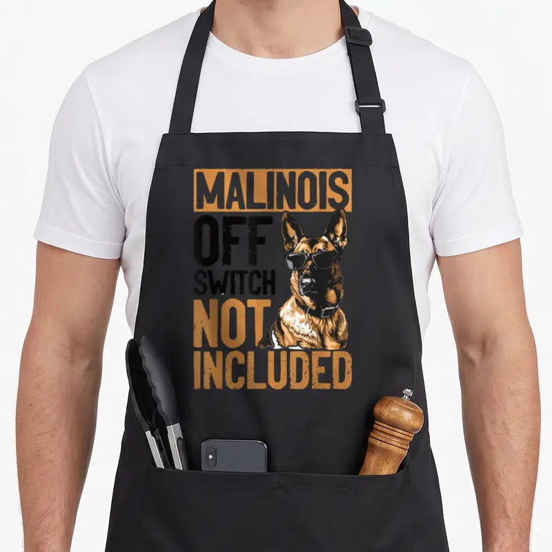 Belgian top dog aprons - Cartoon Malinois dog with sunglasses and text Malinois Off Switch Not Included in orange — shown on a black cotton canvas apron against a white background