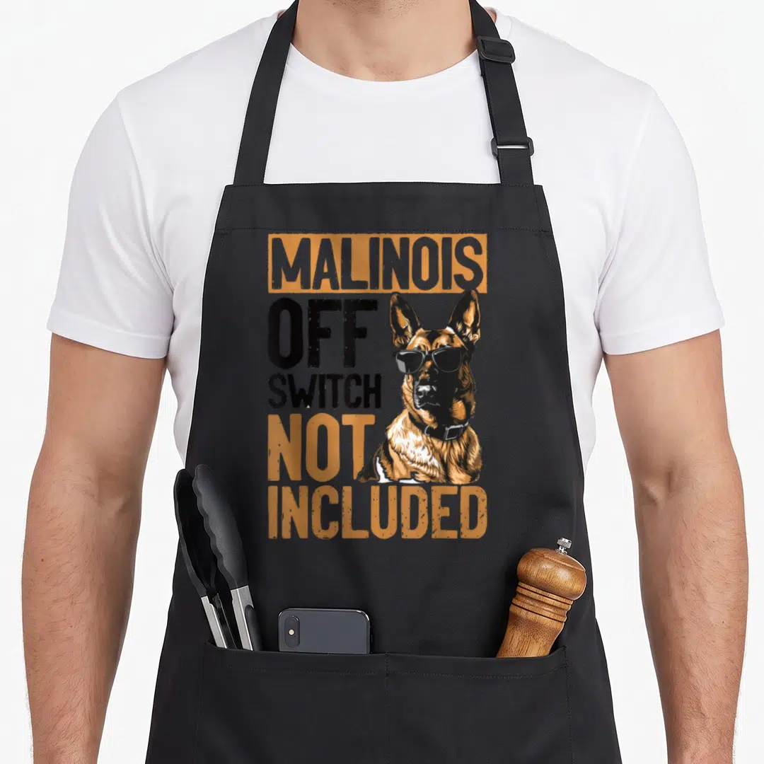 Belgian top dog aprons - Cartoon Malinois dog with sunglasses and text Malinois Off Switch Not Included in orange — shown on a black cotton canvas apron against a white background