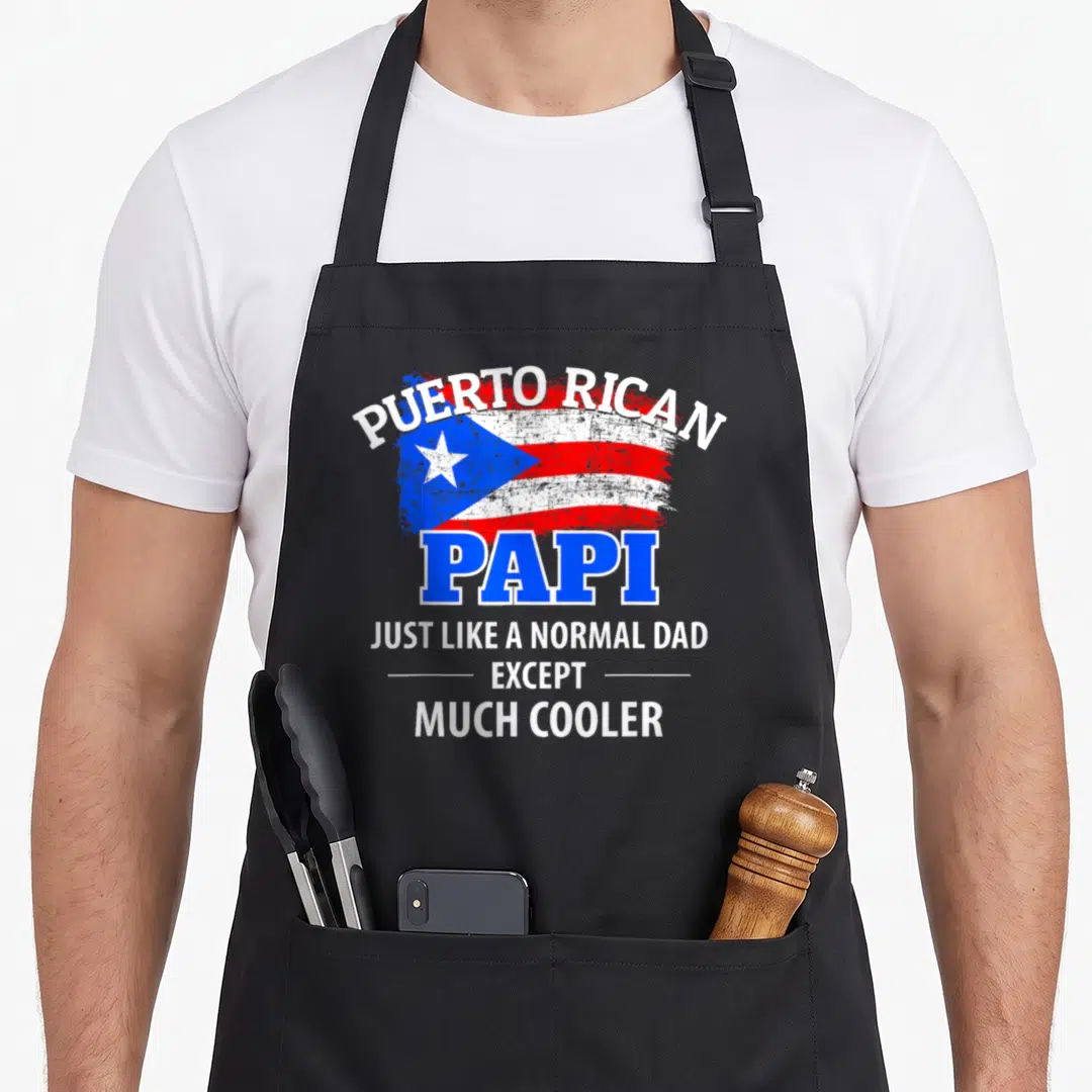 Much dad mode apron - Distressed Puerto Rican flag with arched PUERTO RICAN text and large blue PAPI lettering above — shown on a black cotton canvas apron against a white background