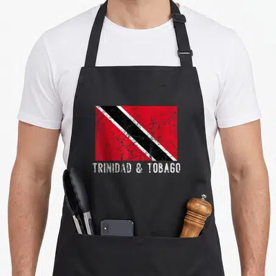 Trinidad distressed apron - Distressed Trinidad and Tobago flag graphic with white text below — shown on a black cotton canvas apron against a white background