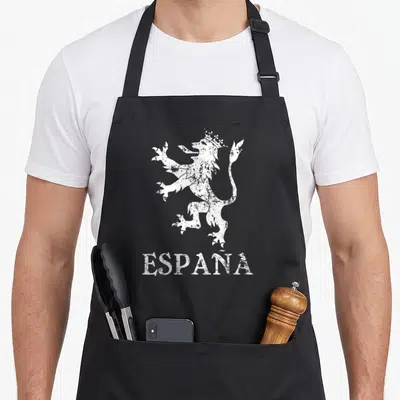 Spaniard spanish aprons - Distressed white crowned lion above ESPAÑA text on black bib apron — shown on a black cotton canvas apron against a white background