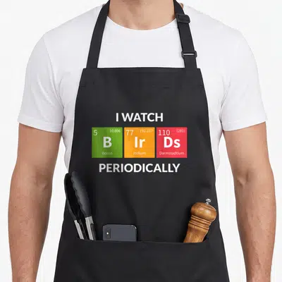 Birding nerd bird apron - I Watch B Ir Ds Periodically periodic table element squares — shown on a black cotton canvas apron against a white background