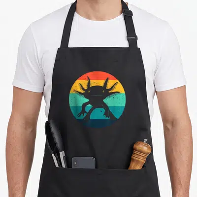 Ambystomatidae animal apron - Grey axolotl silhouette on four retro stripes of red, yellow, teal, and dark blue — shown on a black cotton canvas apron against a white background