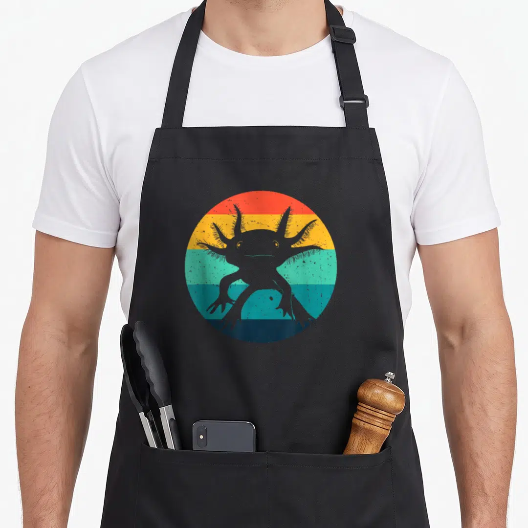 Ambystomatidae animal apron - Grey axolotl silhouette on four retro stripes of red, yellow, teal, and dark blue — shown on a black cotton canvas apron against a white background