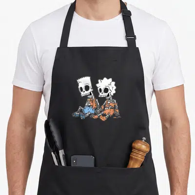 Bart skeleton apron - Two cartoon skeletons in tattered orange and blue clothing sitting side-by-side — shown on a black cotton canvas apron against a white background