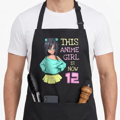 Funny birthday anime mom apron - Anime girl with cat ears and stacked text reading THIS ANIME GIRL IS NOW 12 in teal — shown on a black cotton canvas apron against a white background