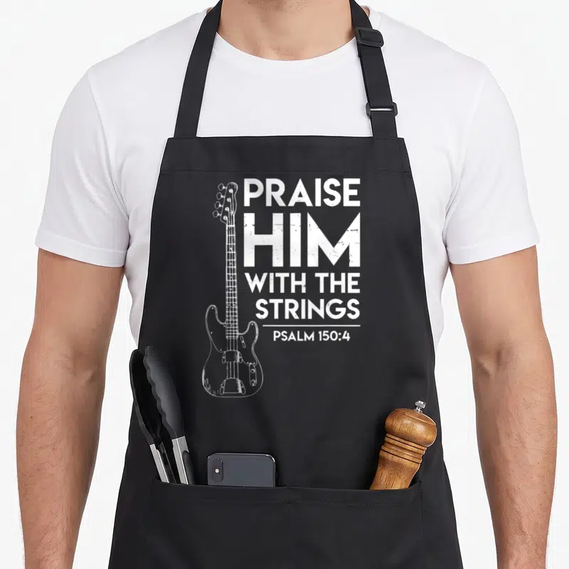 Praise christian apron - White distressed bass guitar and PRAISE HIM WITH THE STRINGS PSALM 150:4 text — shown on a black cotton canvas apron against a white background