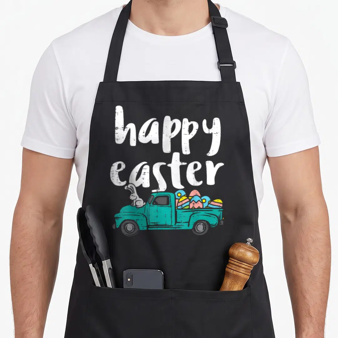 Pickup easter bunny aprons - Teal truck with white bunny and colorful eggs under stacked happy easter text — shown on a black cotton canvas apron against a white background