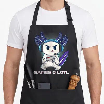 Axolotl video game apron - White cartoon axolotl with purple gills holding controller under GAMES-O-LOTL text — shown on a black cotton canvas apron against a white background