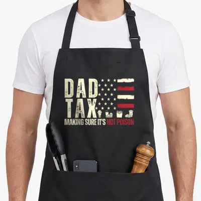 Flag making an apron - Distressed white and red USA flag with DAD TAX text and small icons of ice cream, coffee, fries — shown on a black cotton canvas apron against a white background