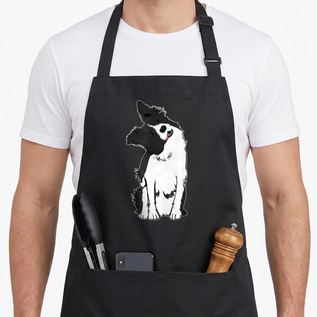 Walky border collie apron - Black and white line art of a sitting border collie facing forward with a head tilt — shown on a black cotton canvas apron against a white background