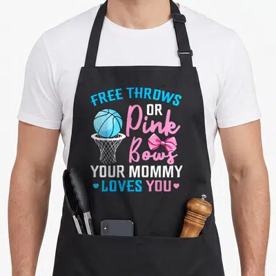 Throw bow apron - Stacked text with blue basketball in hoop, pink bow, small hearts, blue pink white typography — shown on a black cotton canvas apron against a white background