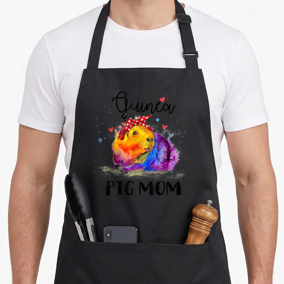 Pig pet apron - Watercolor guinea pig with red bow and hearts, text Guinea PIG MOM — shown on a black cotton canvas apron against a white background