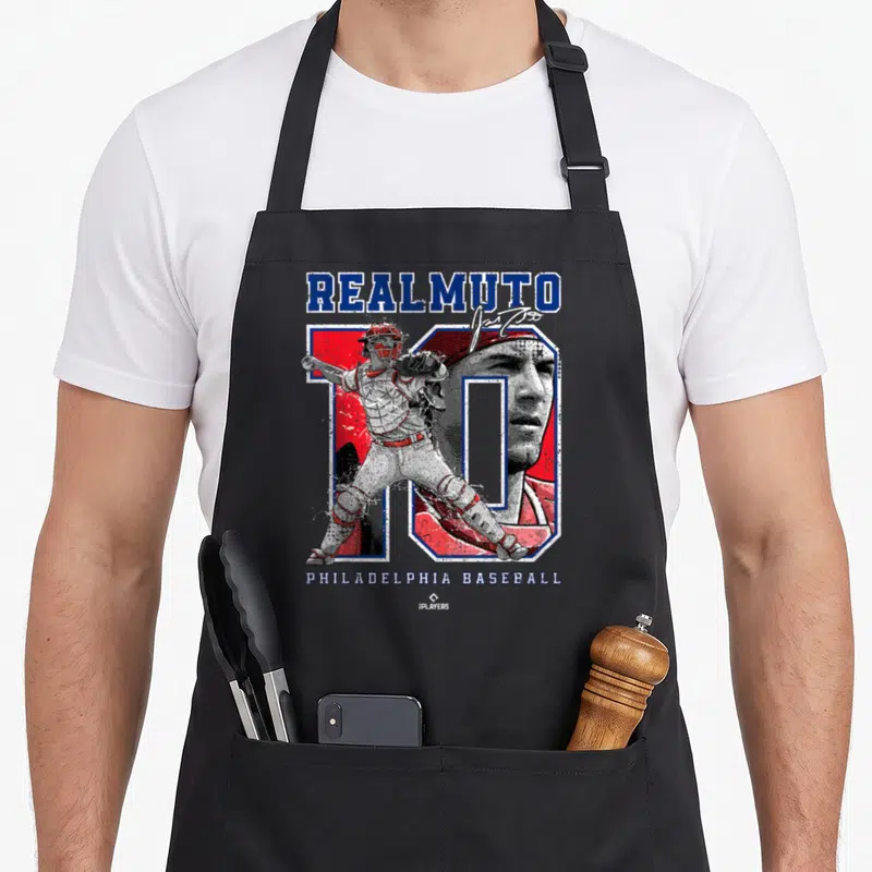 Number ballpark mvp apron - Stacked text reading REALMUTO and PHILADELPHIA BASEBALL with a catcher illustration — shown on a black cotton canvas apron against a white background