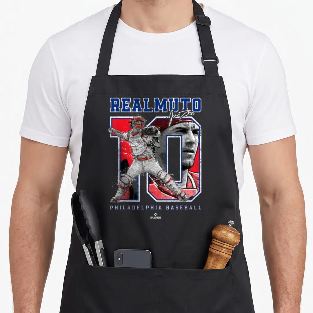 Number ballpark mvp apron - Stacked text reading REALMUTO and PHILADELPHIA BASEBALL with a catcher illustration — shown on a black cotton canvas apron against a white background