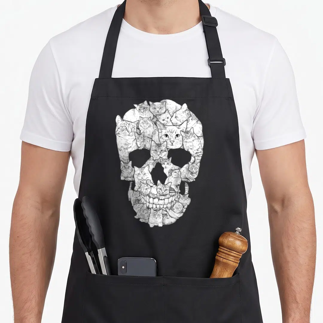 Skull skeleton apron - White line art of cats arranged to form a human skull silhouette — shown on a black cotton canvas apron against a white background