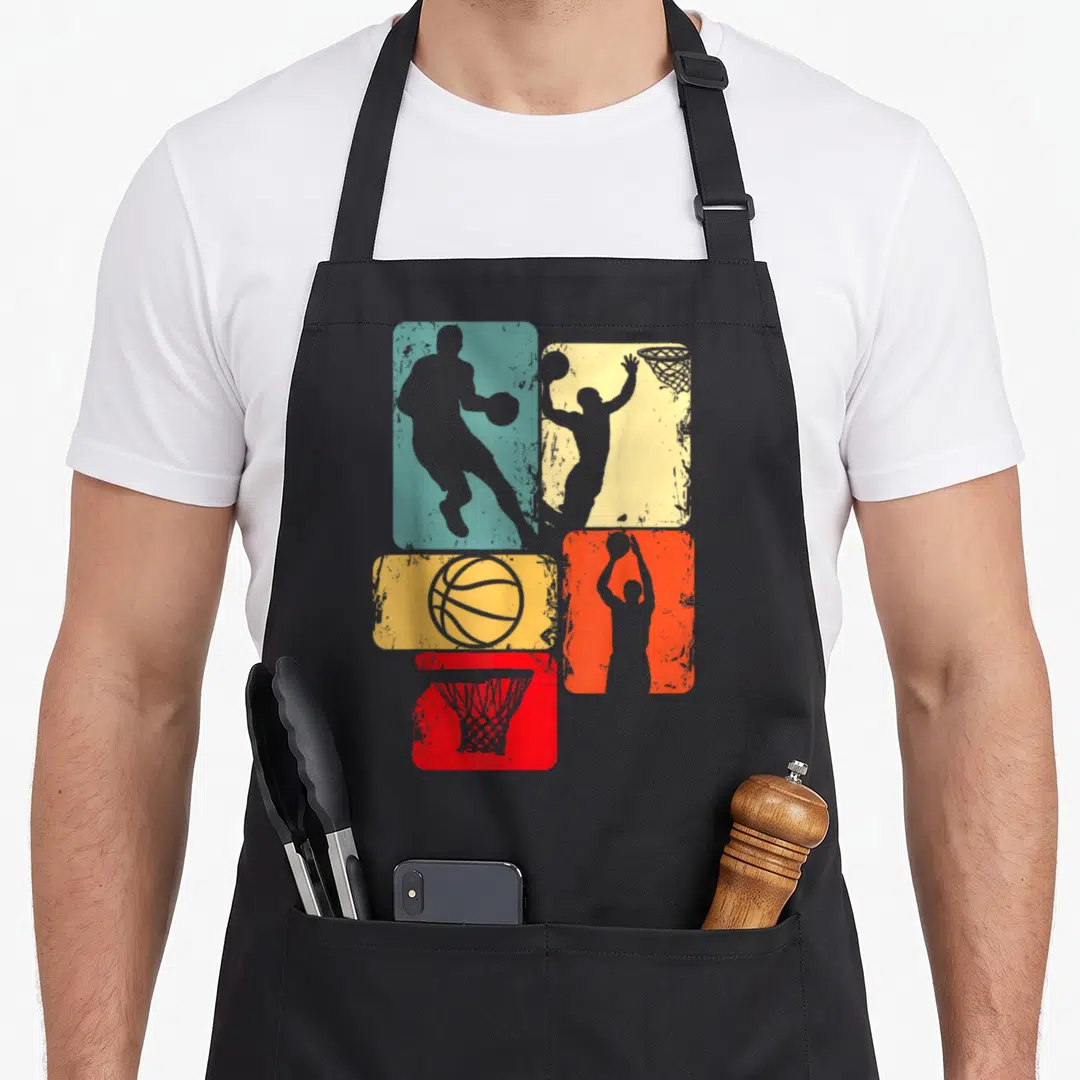 Retro player basketball apron - Four teal yellow orange and red rectangles with grey basketball player ball and hoop — shown on a black cotton canvas apron against a white background