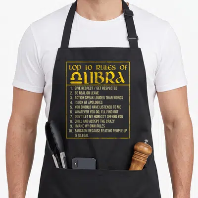 Rule libra birthday apron - Yellow rectangular border containing top 10 rules of libra text list with sarcasm quotes — shown on a black cotton canvas apron against a white background