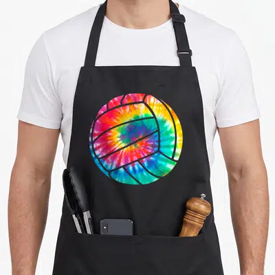 Beach tie-dye apron - Single volleyball with red yellow green blue pink tie-dye pattern — shown on a black cotton canvas apron against a white background