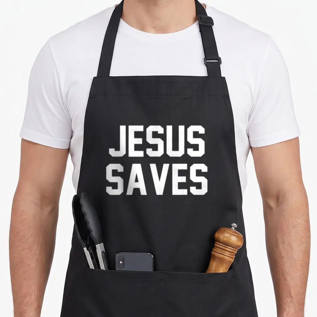 Save christian apron - White JESUS SAVES block text stacked in two lines — shown on a black cotton canvas apron against a white background